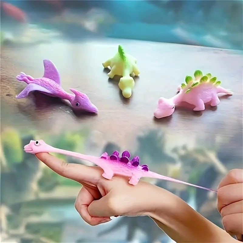 (9x3cm) Finger Stretch Schleuder Dino Flying Anti Stress Spielzeug Fliegender Katapult Dinosaurier - Assortiert