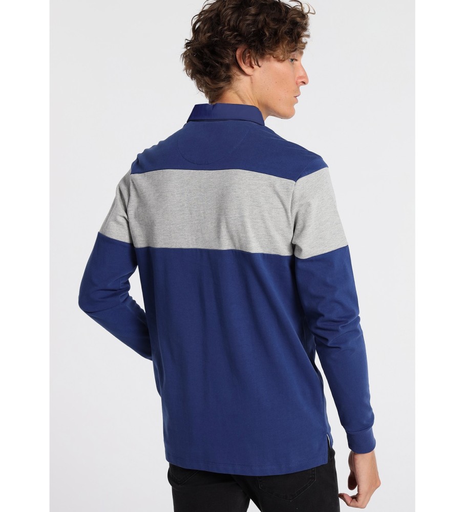 Polo Lois de manga comprida com listra no peito e estampa de selos azuis.