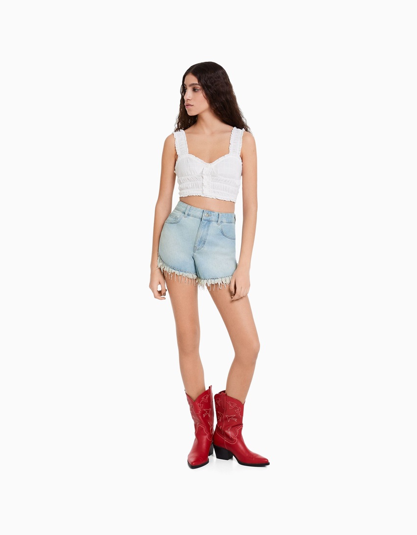 Calções jeans com franjas de strass