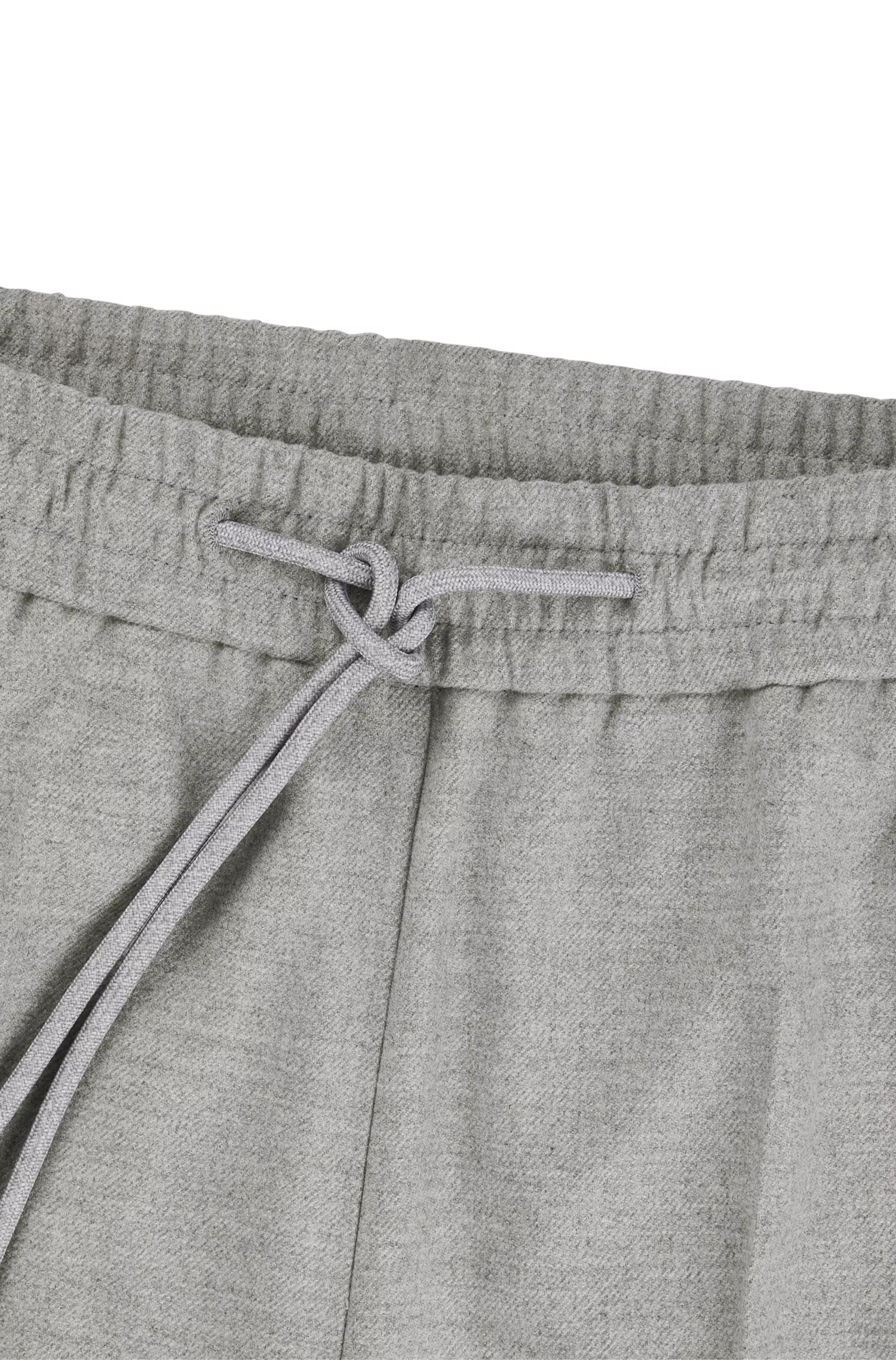 Calça BOSS preta, corte relaxado, com detalhe da marca no cós.