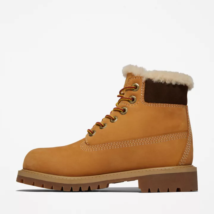 Bota de inverno Timberland Premium de 6 polegadas para jovens, na cor amarela.