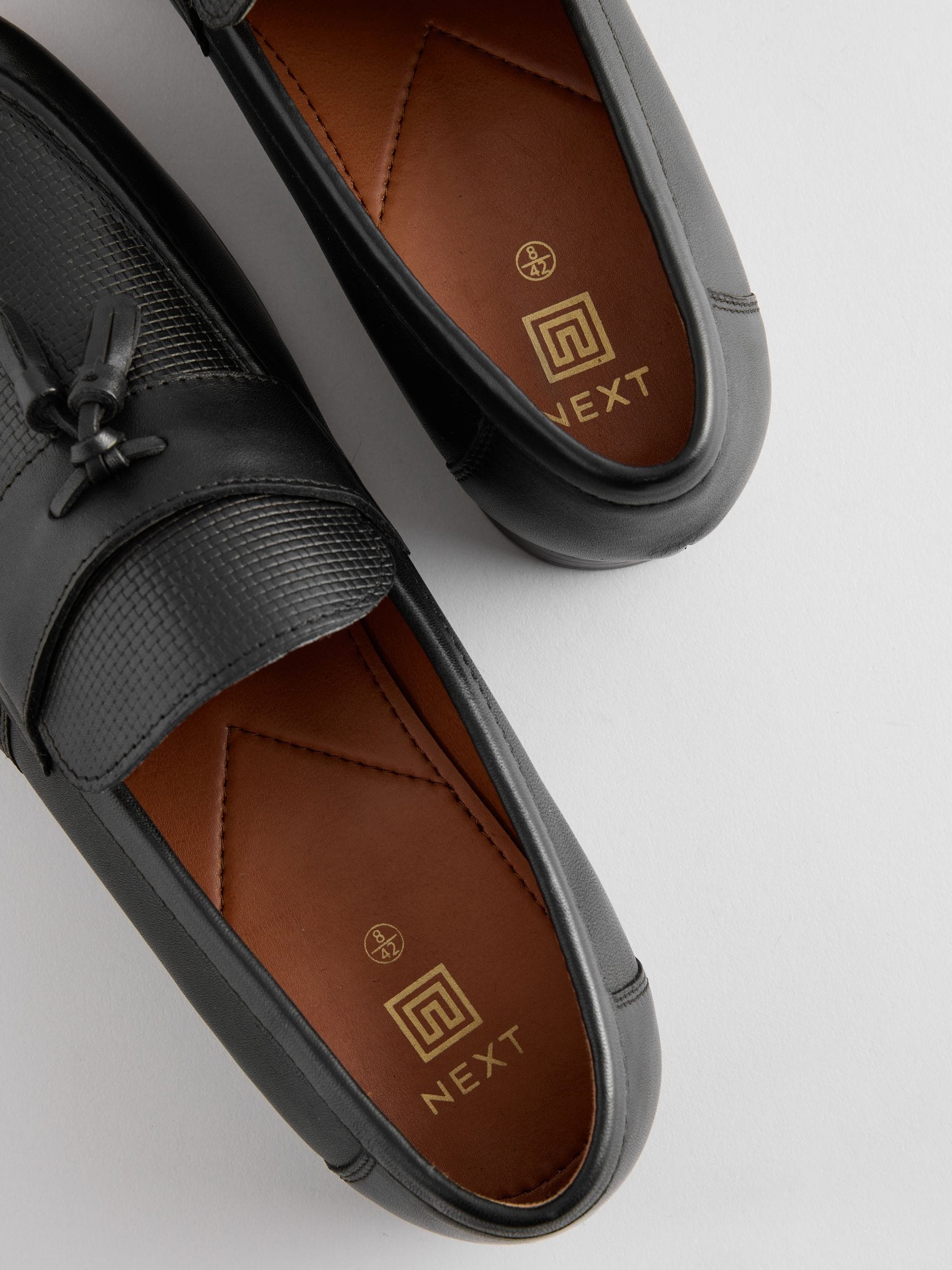Zwart - Leren loafers met reliëf en kwastjes