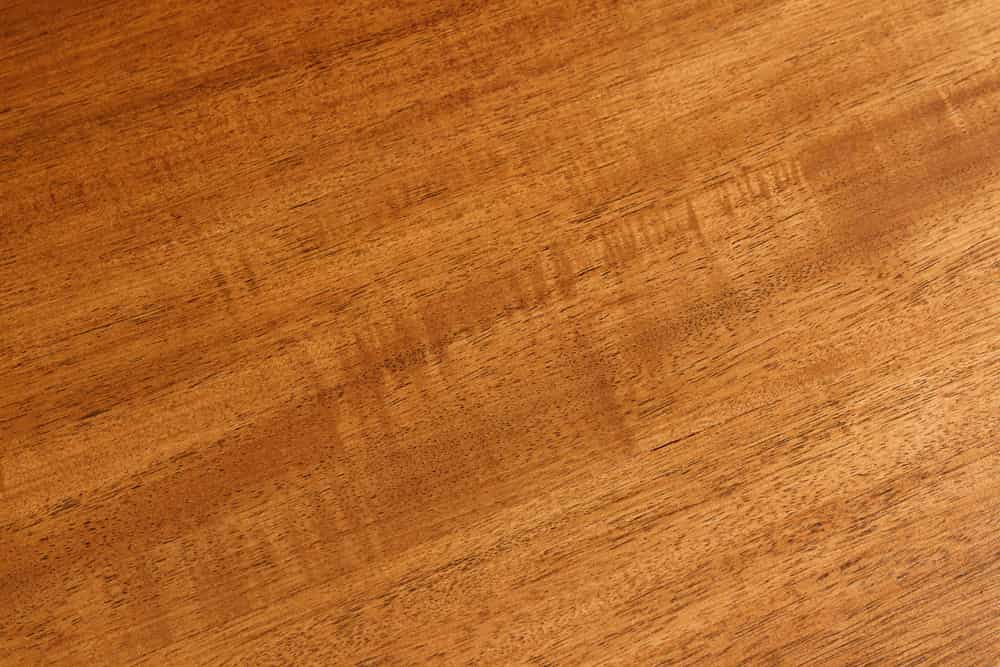 Massiver Couchtisch GENESIS 110cm braun Akazienholz Baumkante V-Gestell