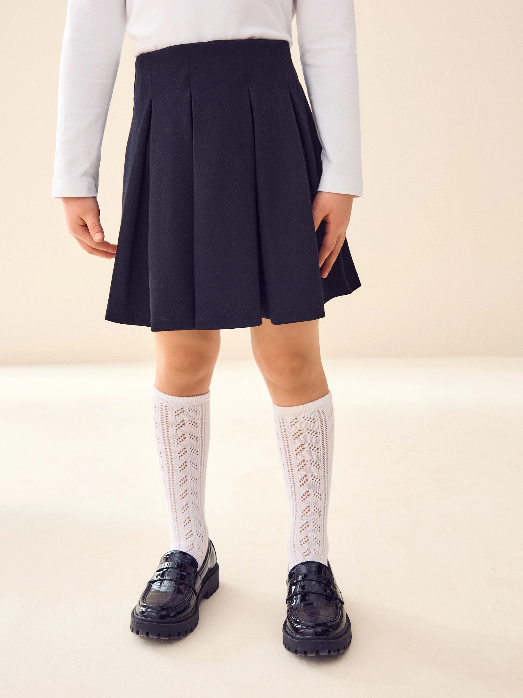Zwart - Jersey pull-on geplooide schoolrok met stretch (3-17jr)