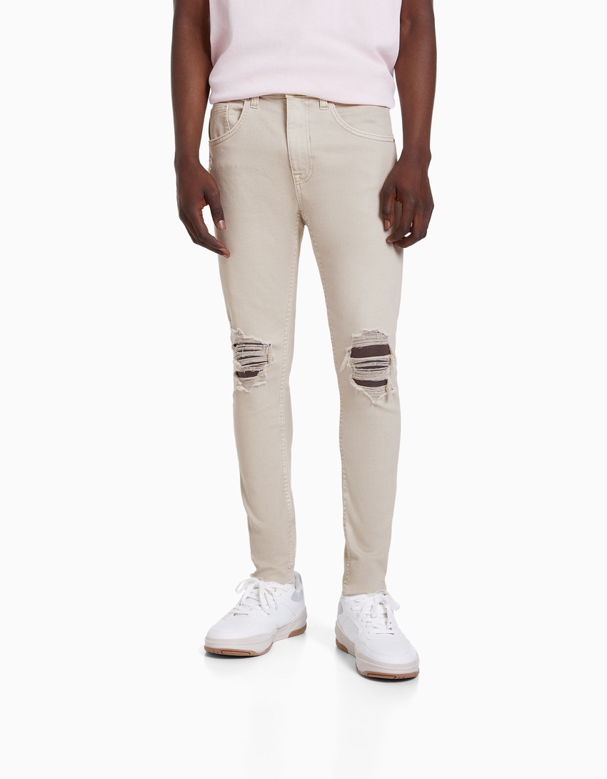 calça jeans super skinny rasgada