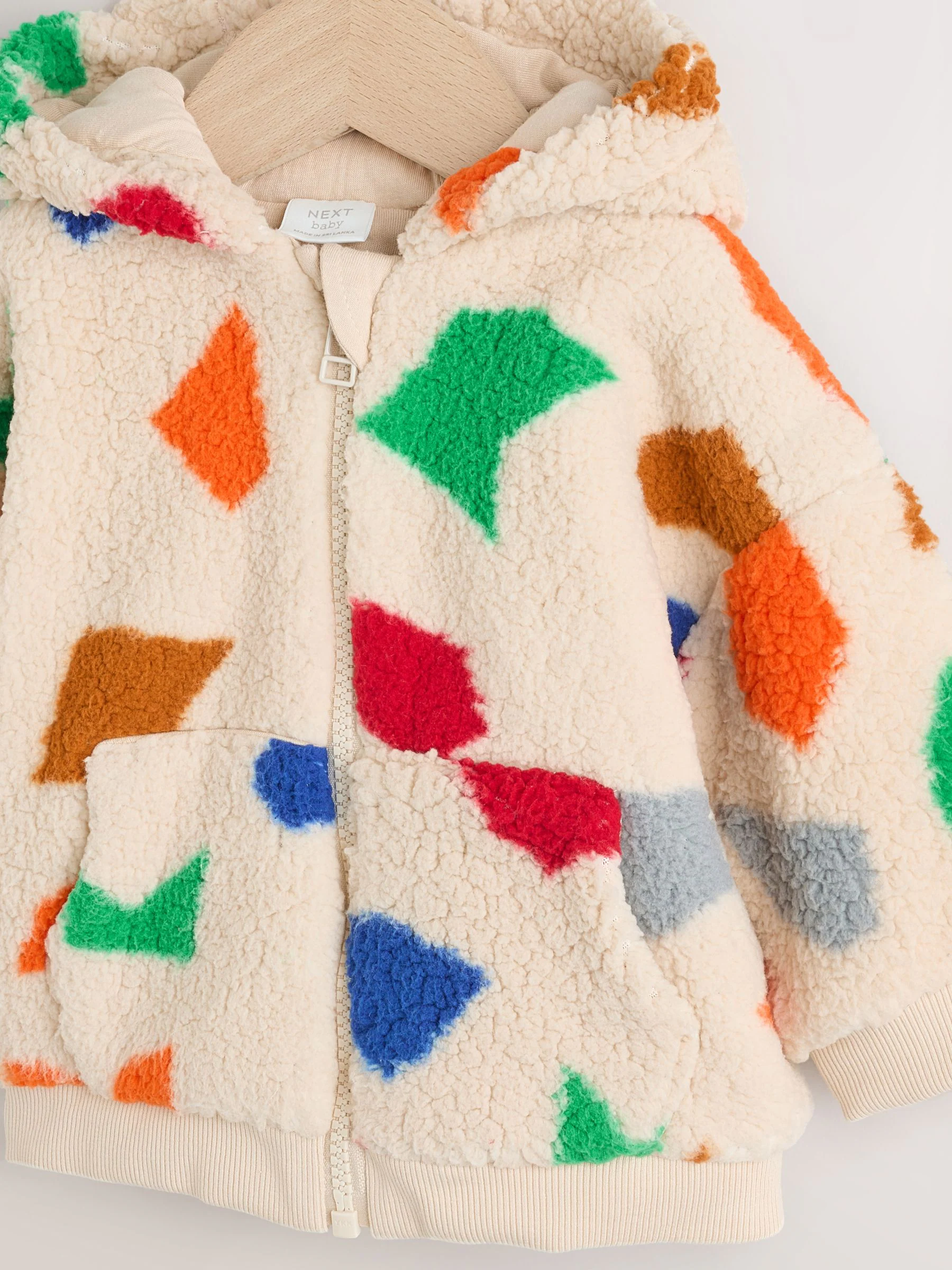 Natuurlijk felgekleurd met geometrische print - Babyjack met rits en capuchon (0mnd-2jr)