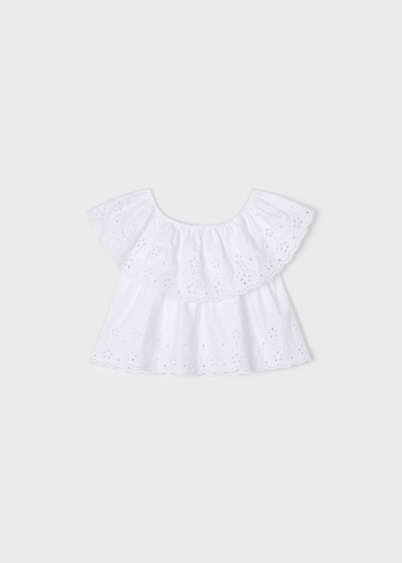 Blusa com motivos perfurados, feita de algodão sustentável, para meninas.