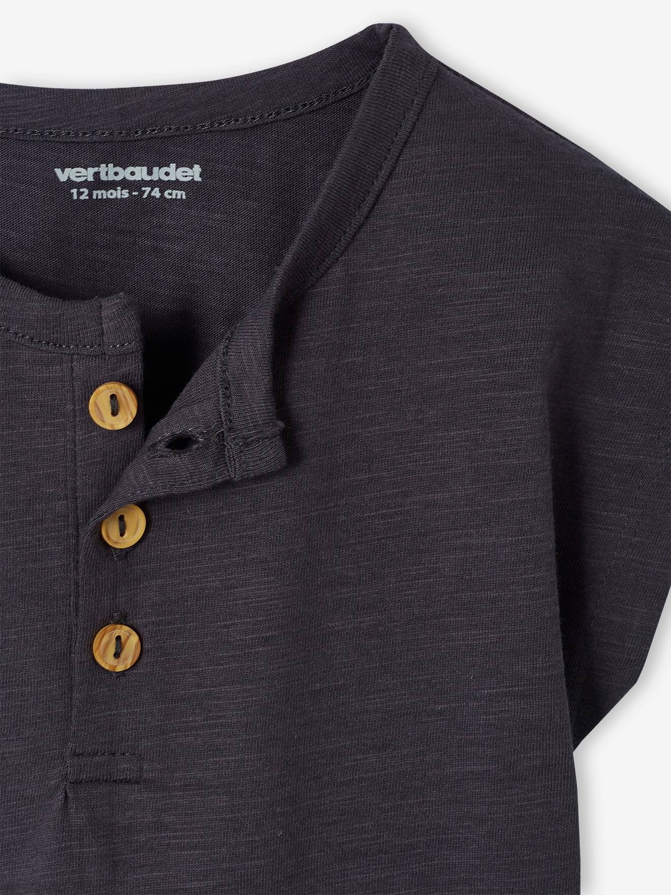 Roupa de bebê: camiseta listrada bege e jardineira.