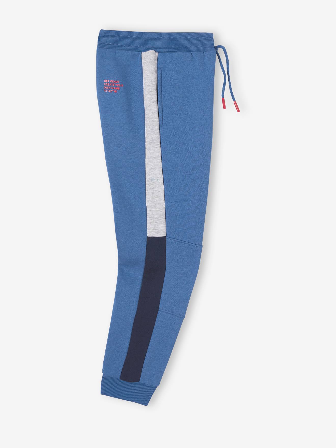 Calça de fato de treino infantil feminina em fleece preto liso com riscas bicolores nas laterais.