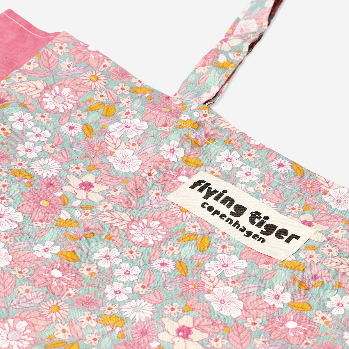 Blomsterformet mulepose med pink detaljer