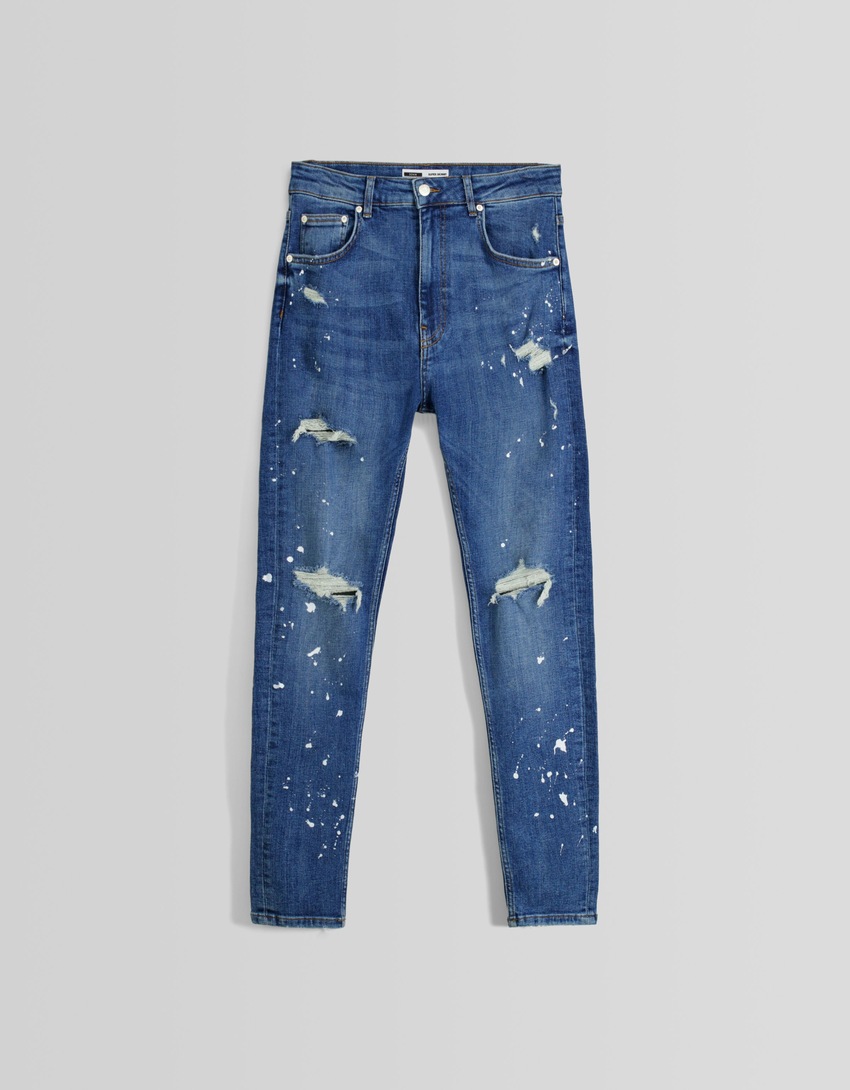 Calça jeans super skinny rasgada com respingos de tinta