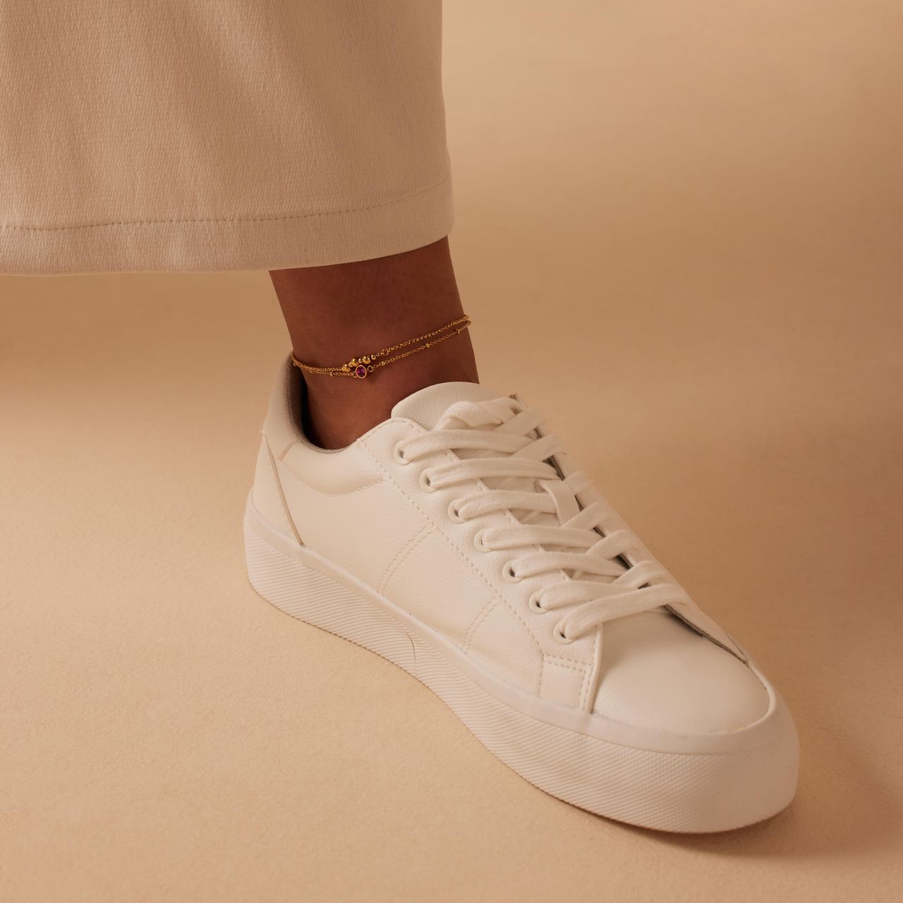 Dubbele goldplated stalen enkelbandje met steentje