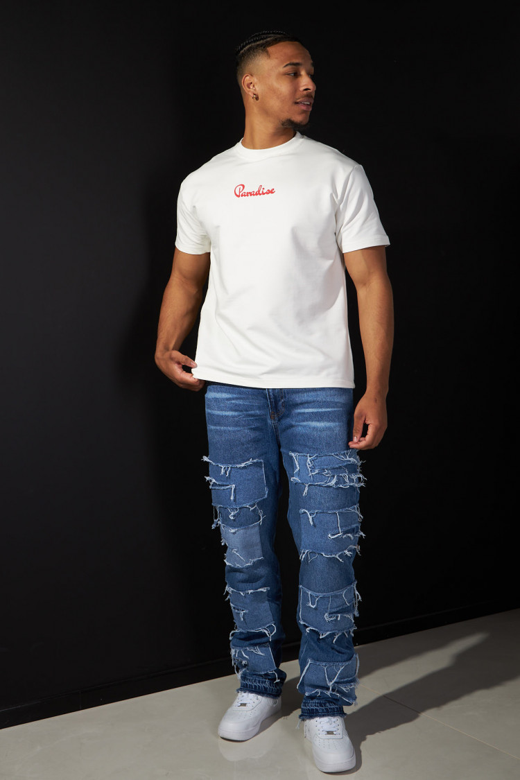 Jean bleu à empiècement sur les cuisses déchiré