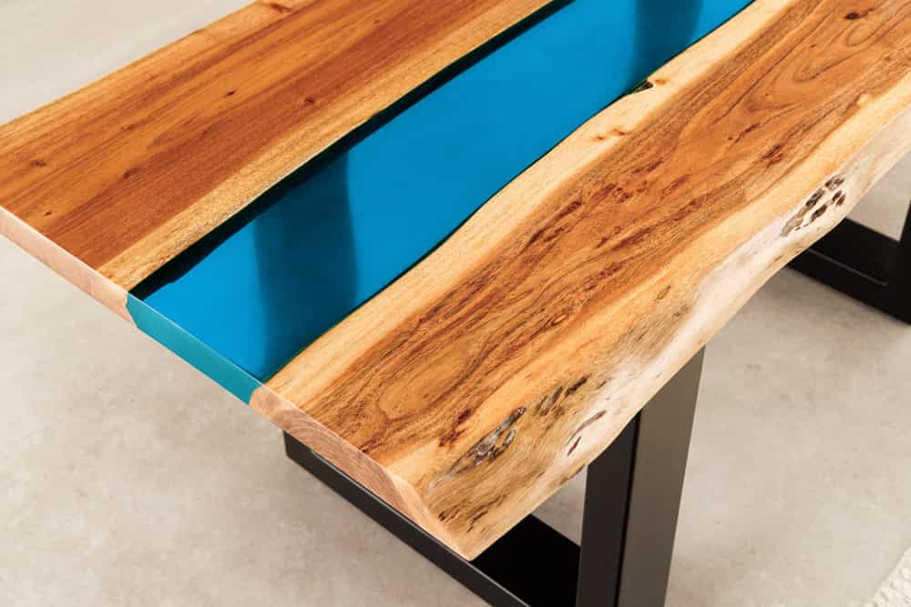 Massiver Couchtisch LIQUID 110cm braun Akazienholz Baumkante schwarz Eisen blau