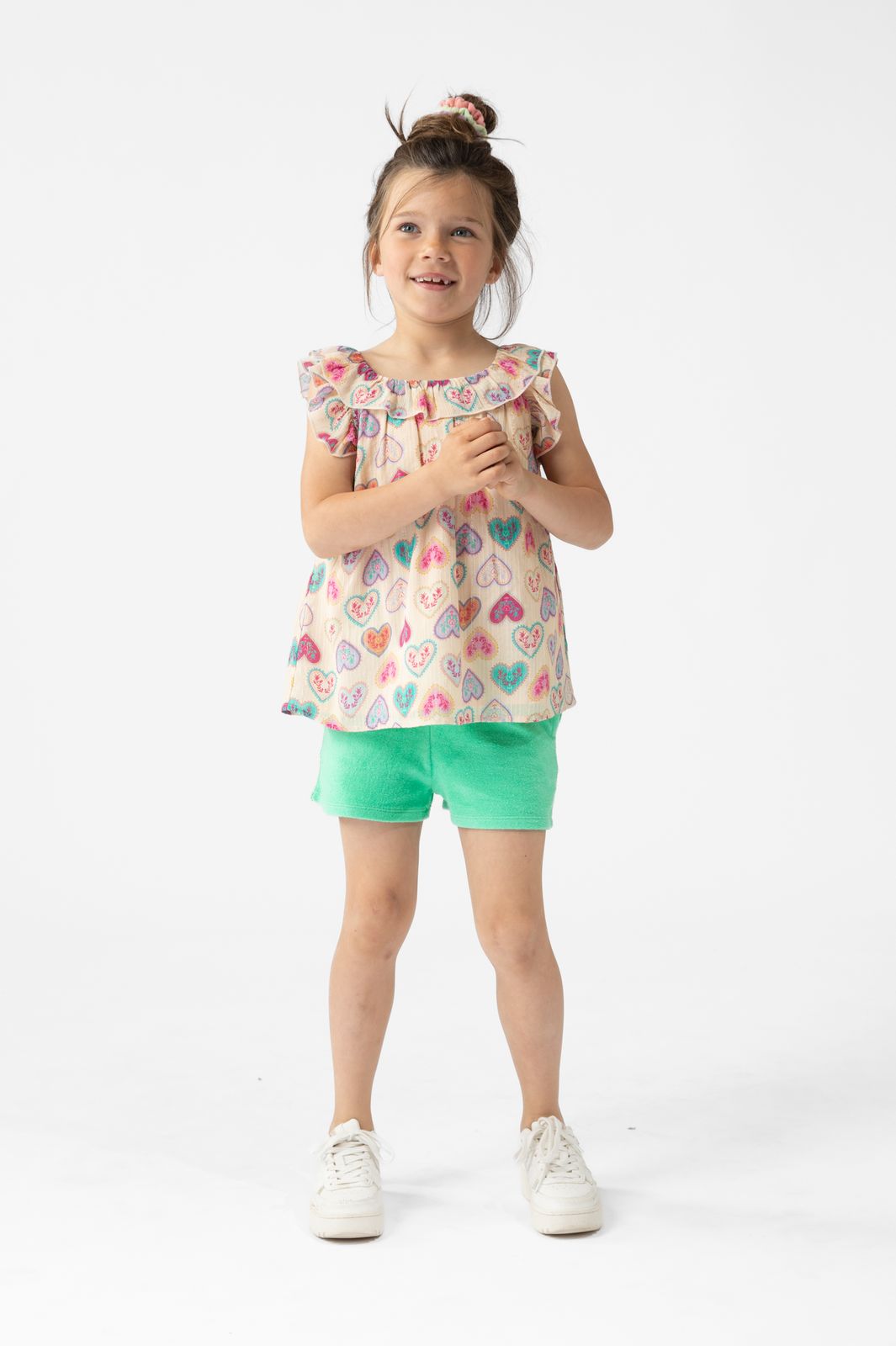 Lichtoranje top met ruffles en hartjes