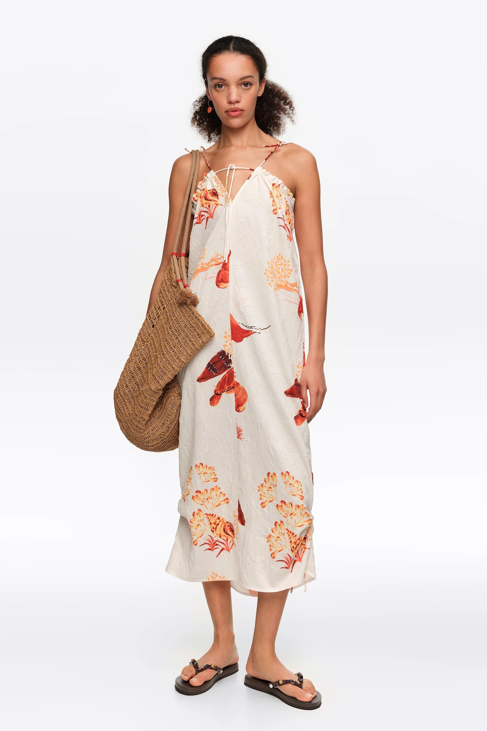 Vestido midi laranja com estampa de tartaruga e alças ajustáveis.