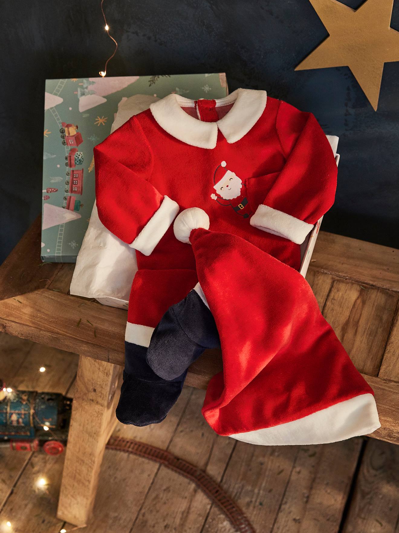 Conjunto de presente de Natal para bebê, composto por body e gorro, na cor vermelho escuro liso com estampas.