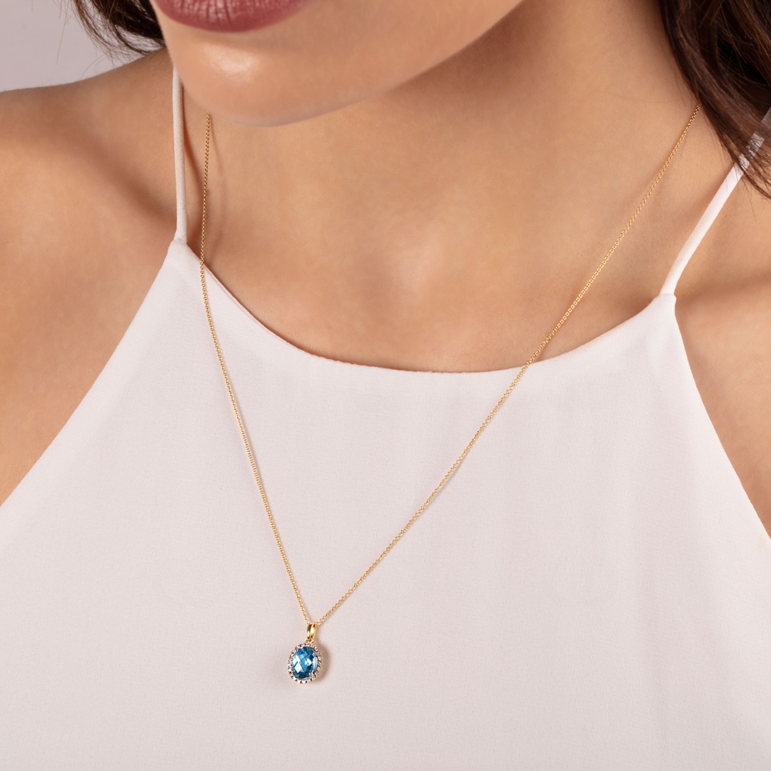 Anhänger 750/18 K Gelbgold mit Blautopas oval und Diamanten 0.06 ct H/si
