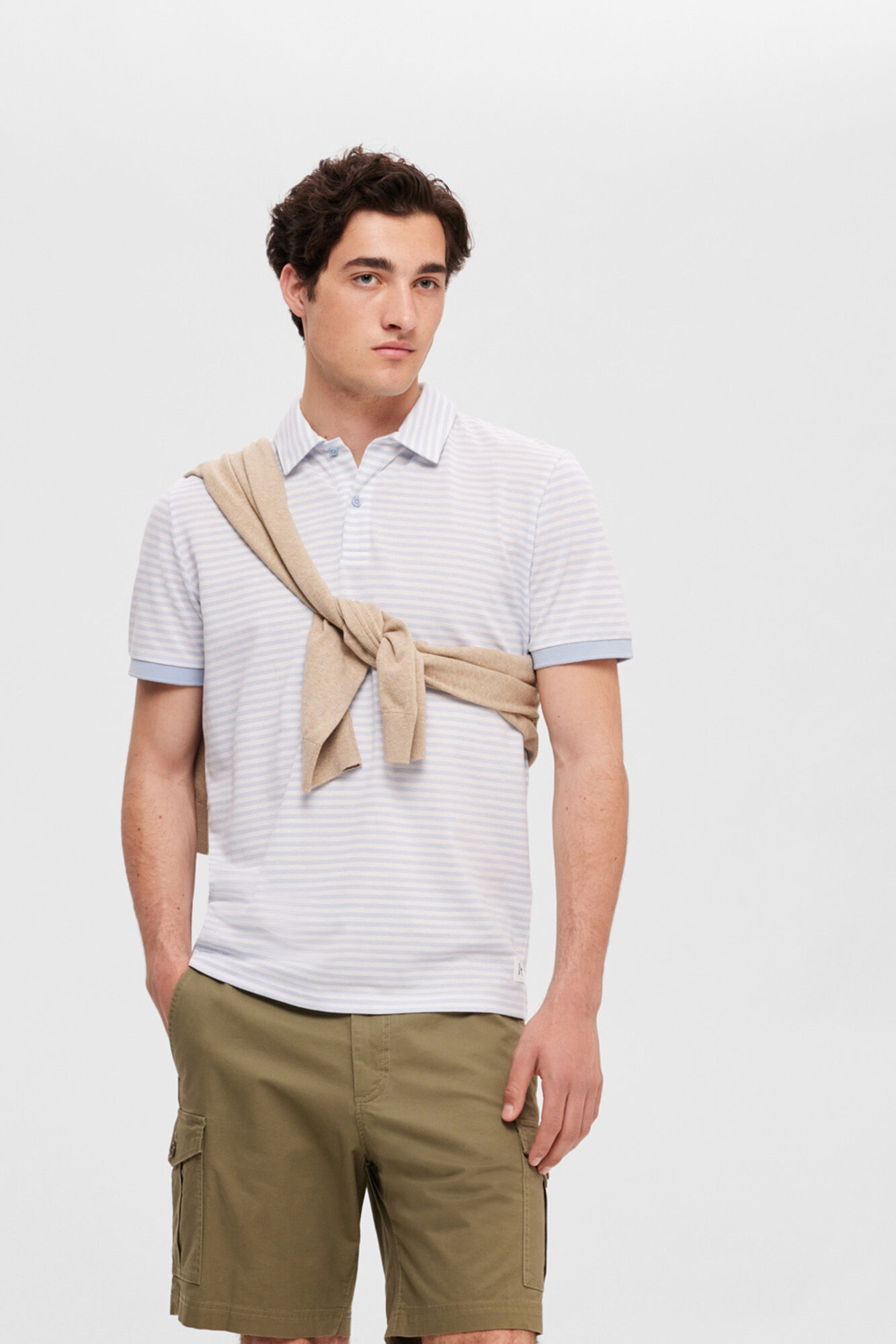 Camisa polo listrada de manga curta em algodão orgânico. - Azul