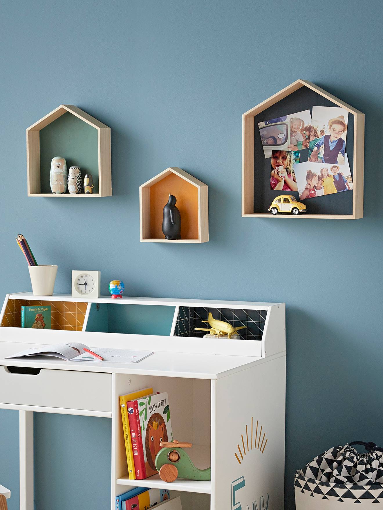 Conjunto de 3 prateleiras de madeira multicoloridas em formato de casa.