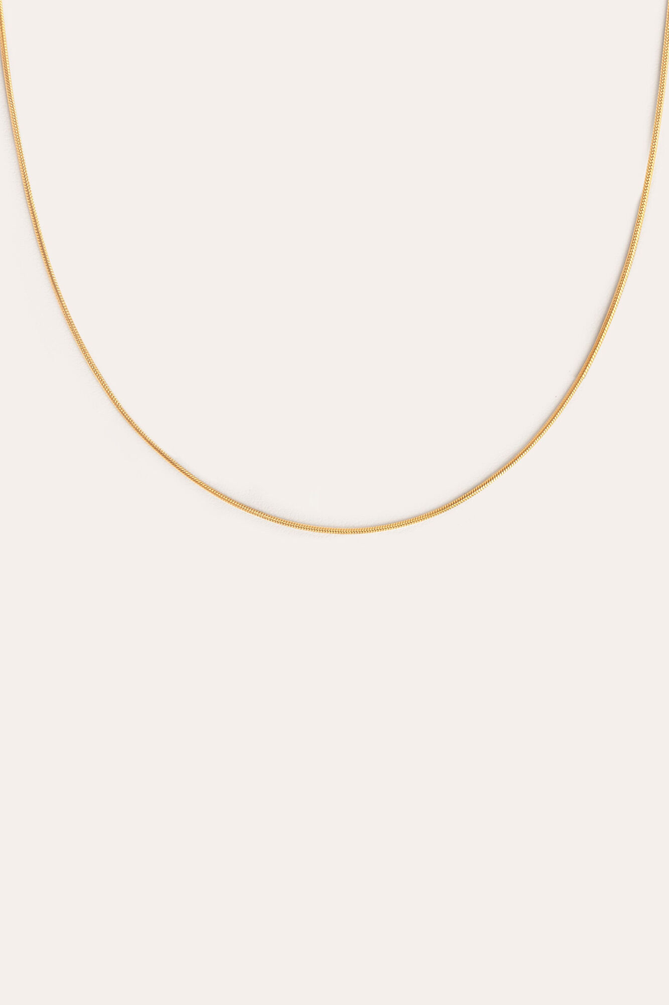 Colar com cauda em aço banhado a ouro