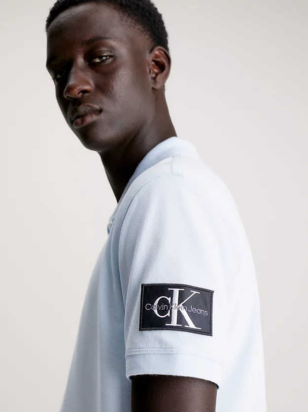 Camisa polo com brasões