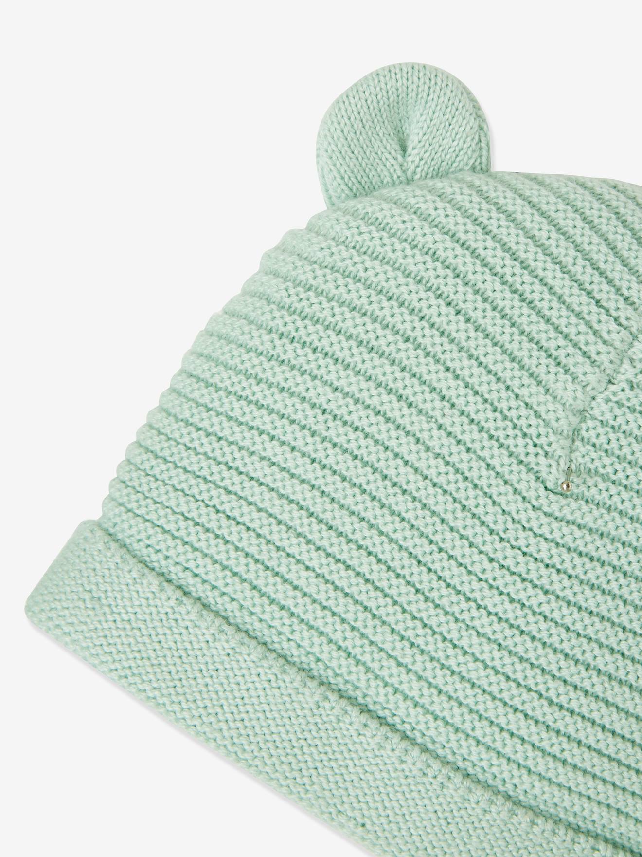 Conjunto para recém-nascido com gorro, luvas e sapatinhos, acompanhado de bolsa azul-marinho combinando.