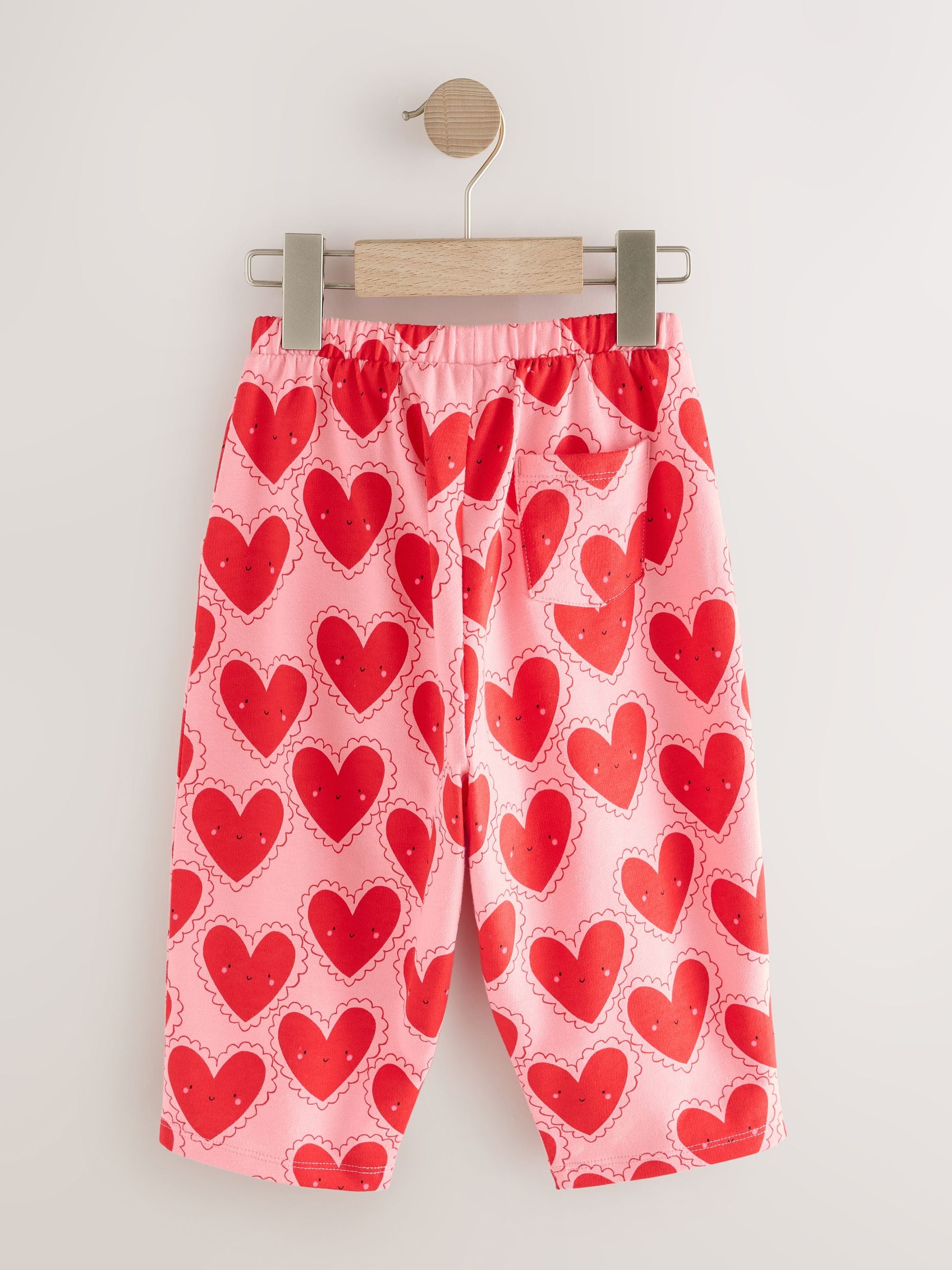 Rood met hartjesprint - Broek met structuur en wijde kortere pijpen (3mnd -7jr)