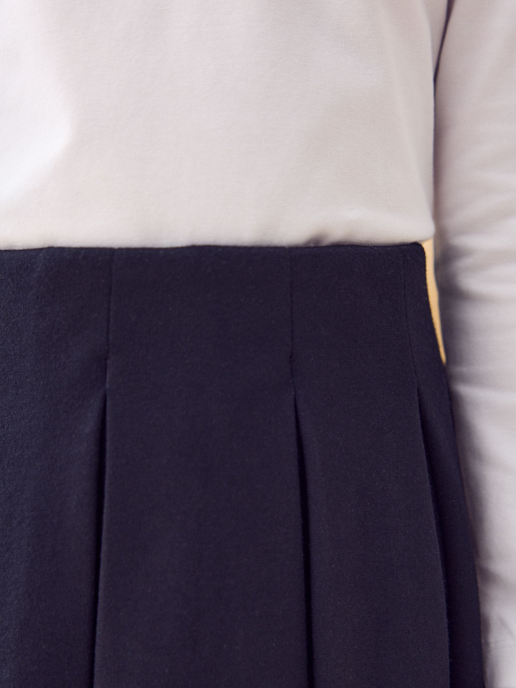 Zwart - Jersey pull-on geplooide schoolrok met stretch (3-17jr)