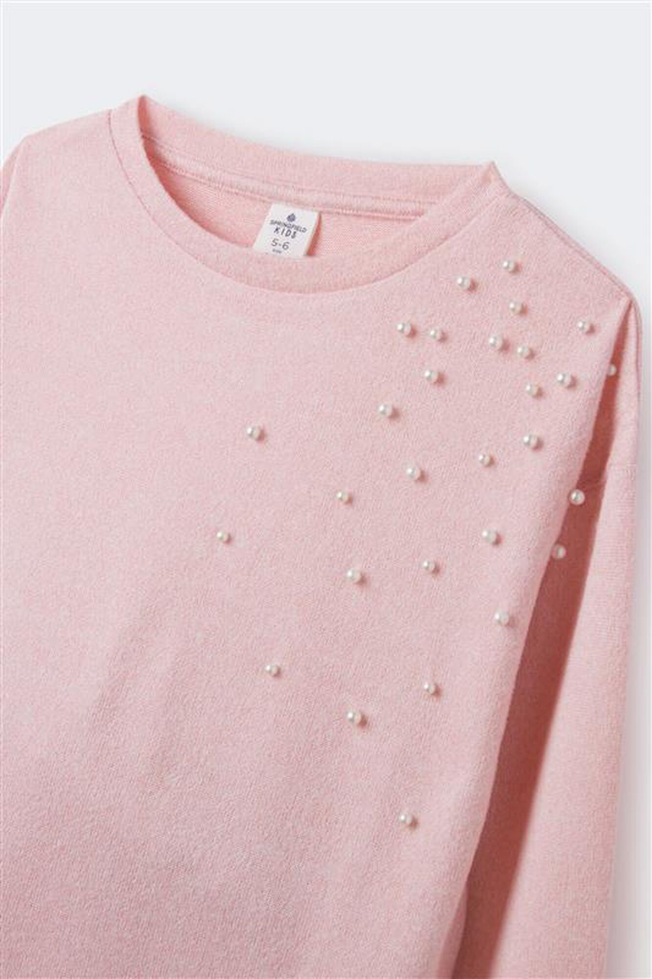 Camiseta de manga comprida feminina com pérolas.