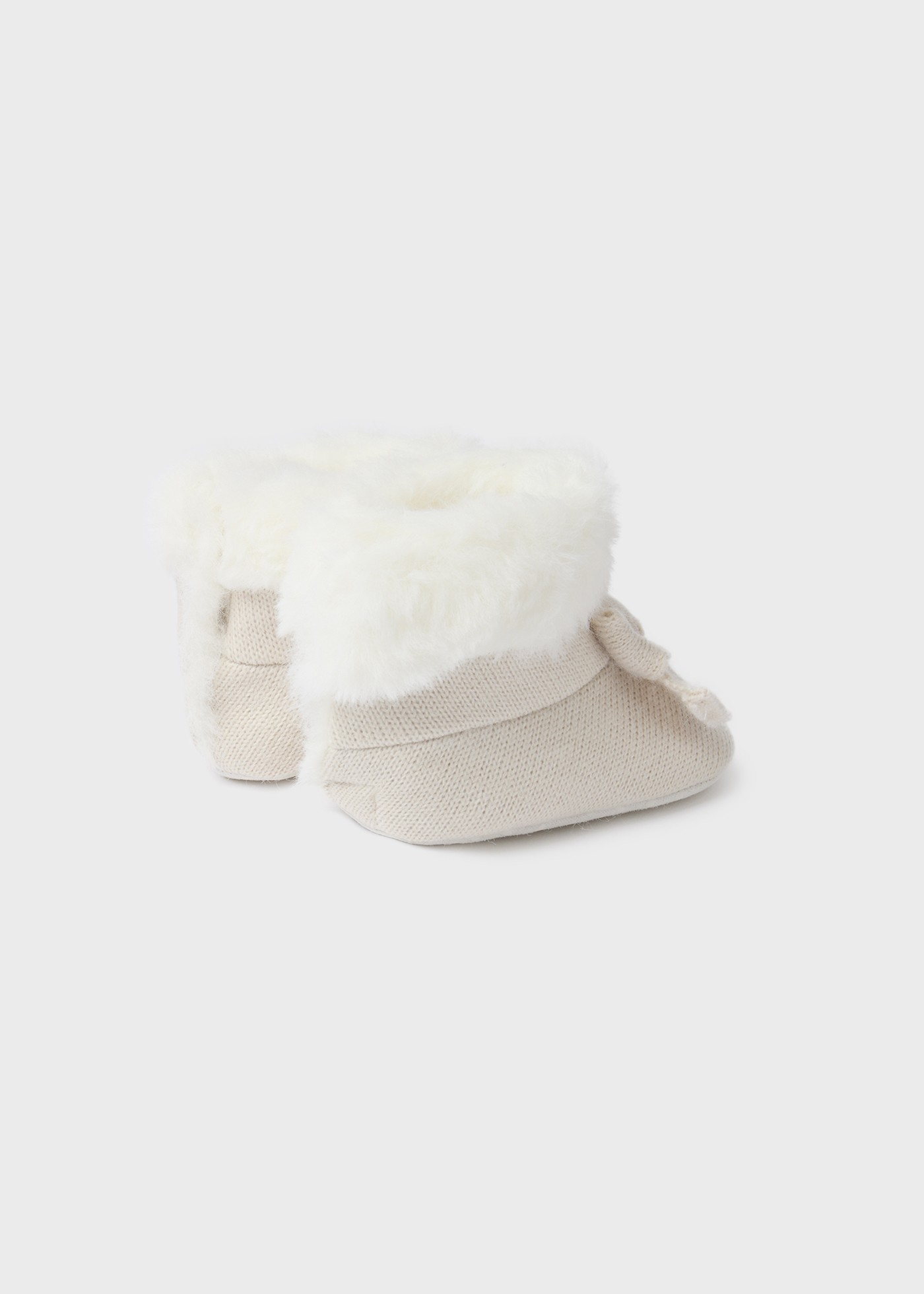 Bota de tricô com pelo de recém-nascido