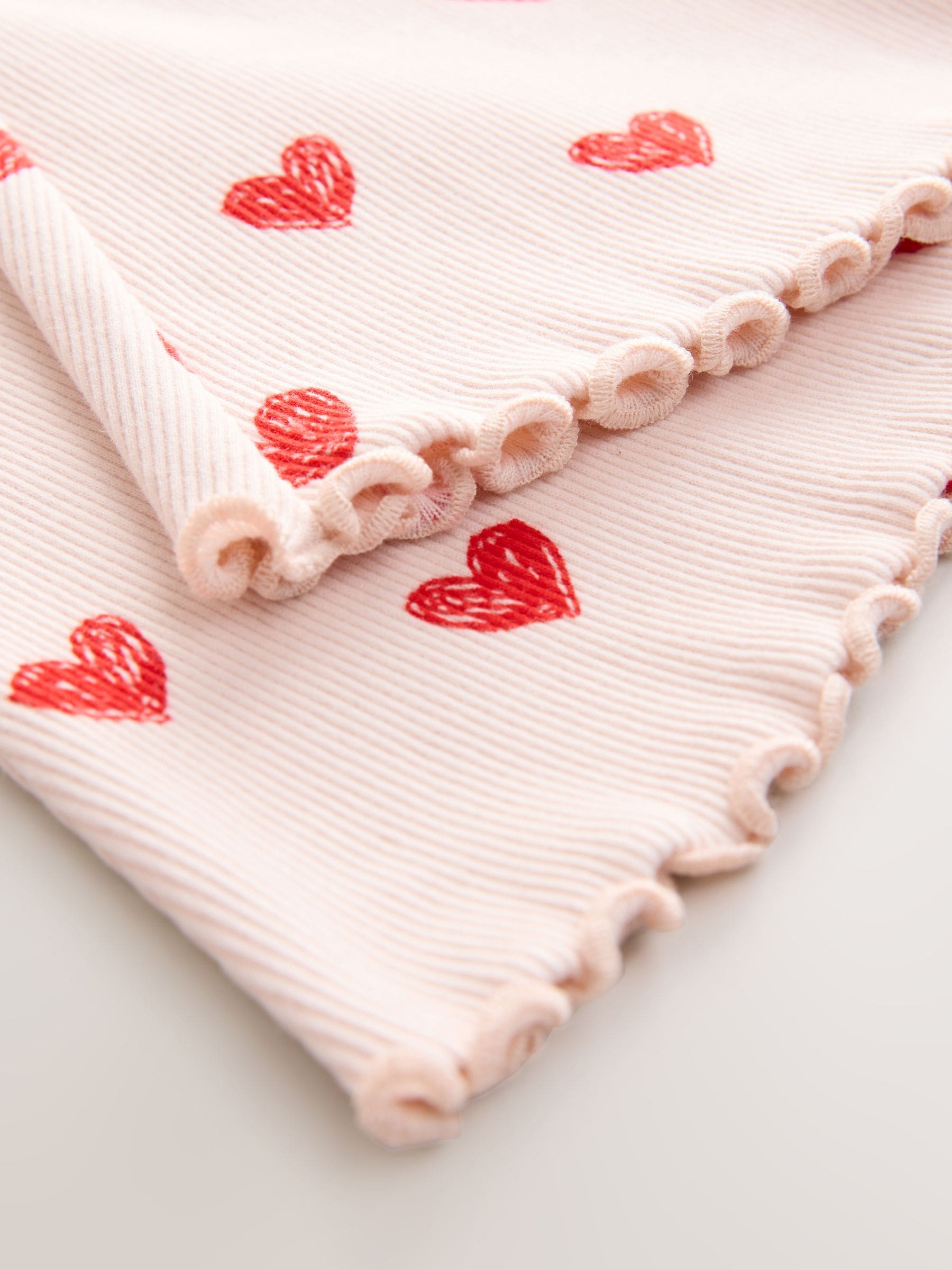 Lichtroze met hartje - Geribbelde flare legging (3 mnd-7 jr)