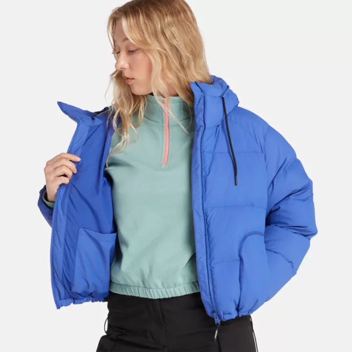 Jaqueta puffer feminina de plumas recicladas na cor azul.