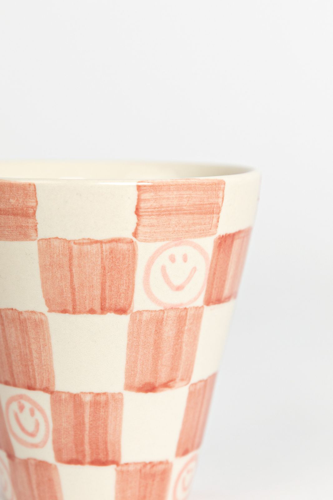 Roze geblokte beker met smileys