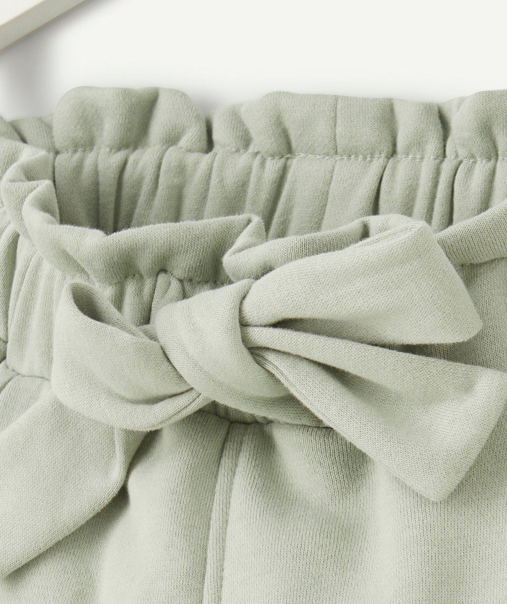 JOGGING FILLE EN FIBRES RECYCLÉES VERT AVEC NOEUD ET LISERÉS PAILLETÉS