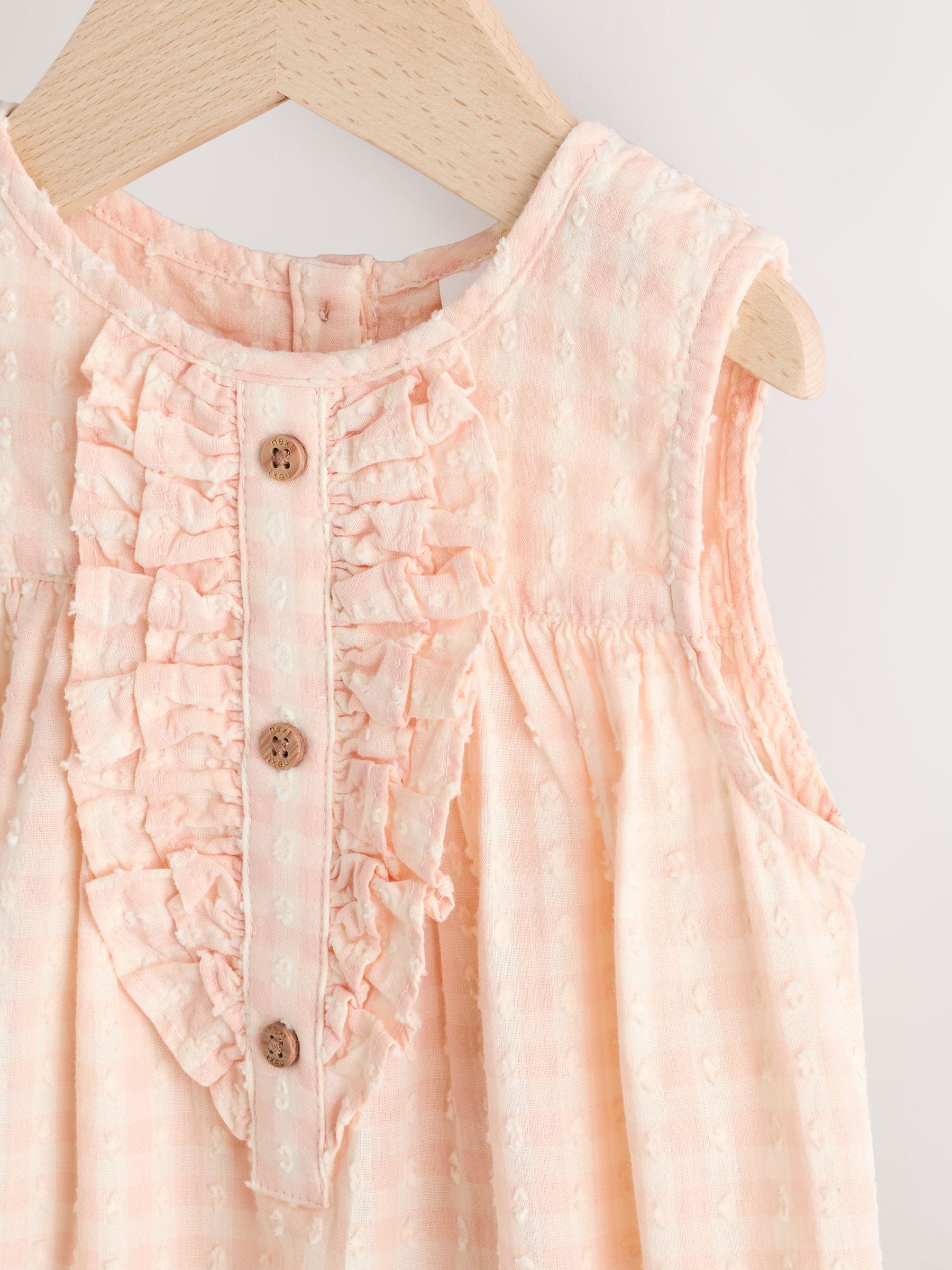 Perzikroze gingham-ruit - Babyromper met ruches (0mnd-2jr)