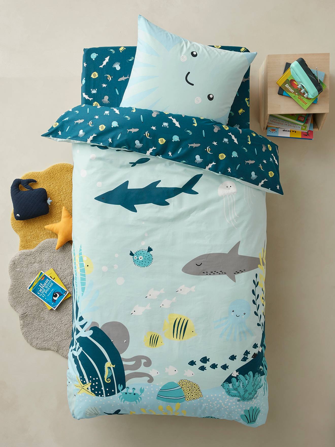 Lençol infantil com elástico, estampa de fundo verde-escuro com motivos marinhos.