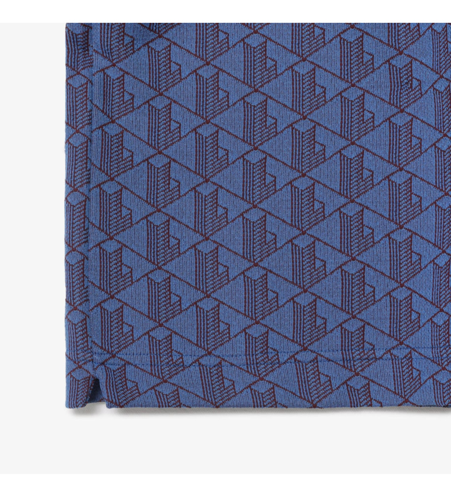 Polo Lacoste de corte clássico com gola contrastante e monograma azul.