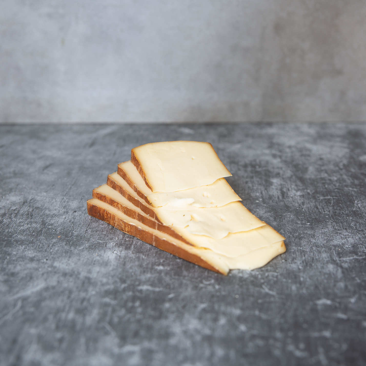 Fromage à raclette tranché fumé