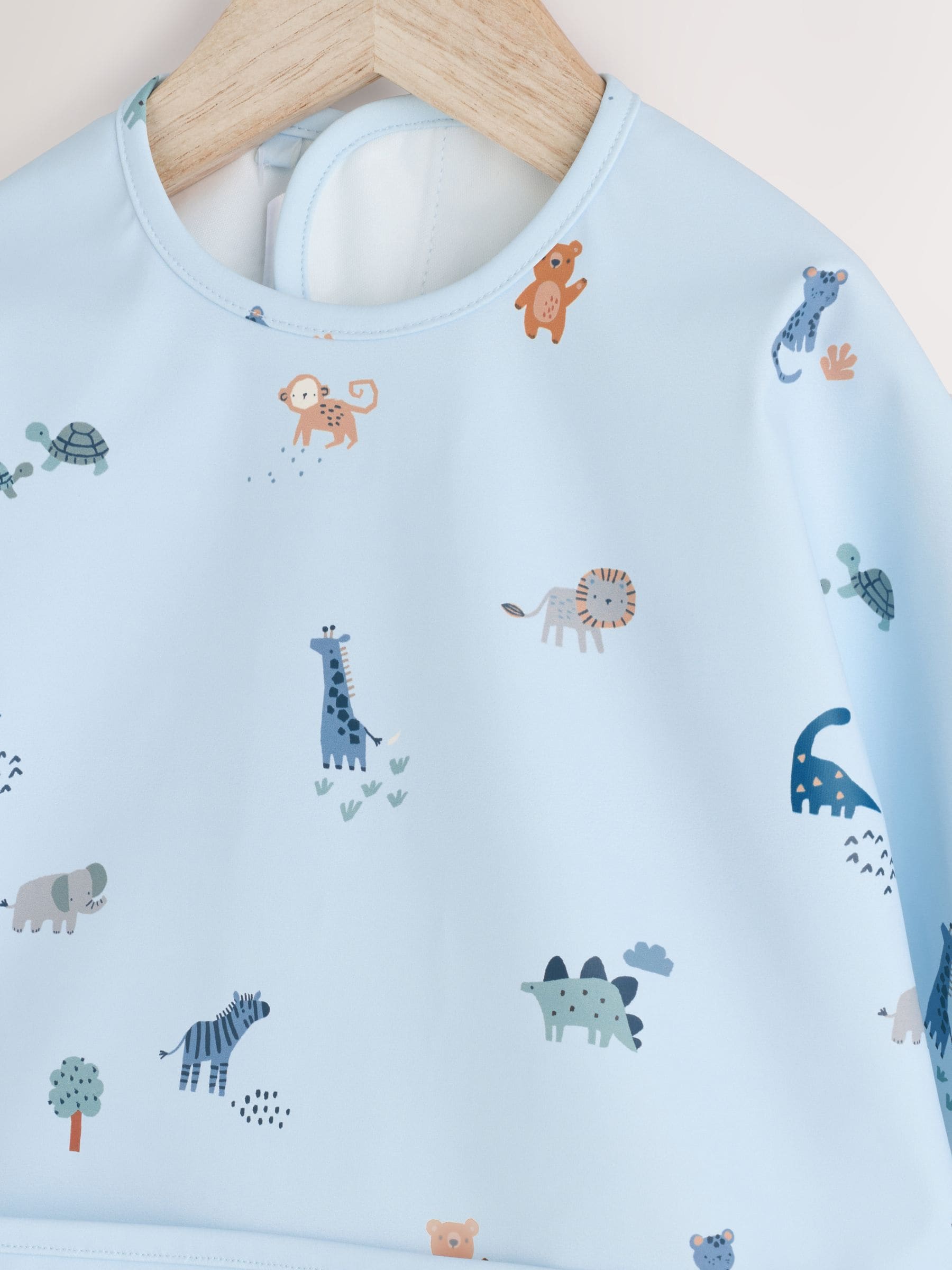 Blauw Dino Jungle - Slabbetje met mouwen voor spenen en voeden
