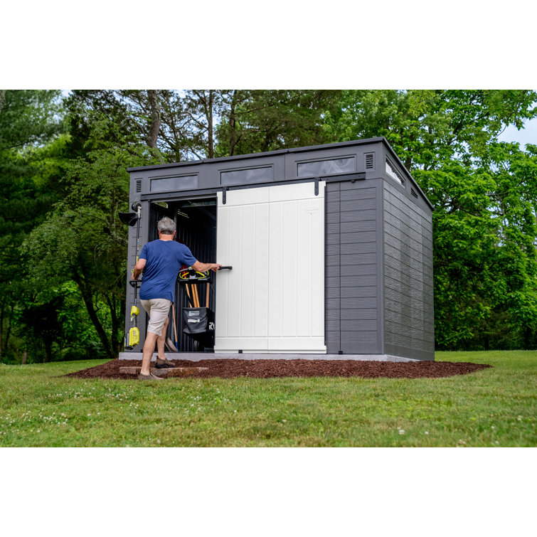 Casinha de armazenamento Suncast Modernist com porta de celeiro, 3,29 m de largura x 2,22 m de profundidade, em resina.