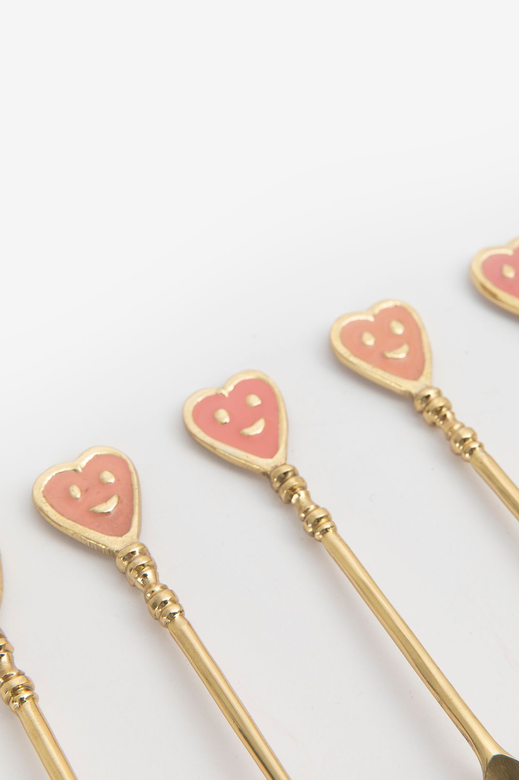 Roze en goudkleurige theelepels smiley hartjes