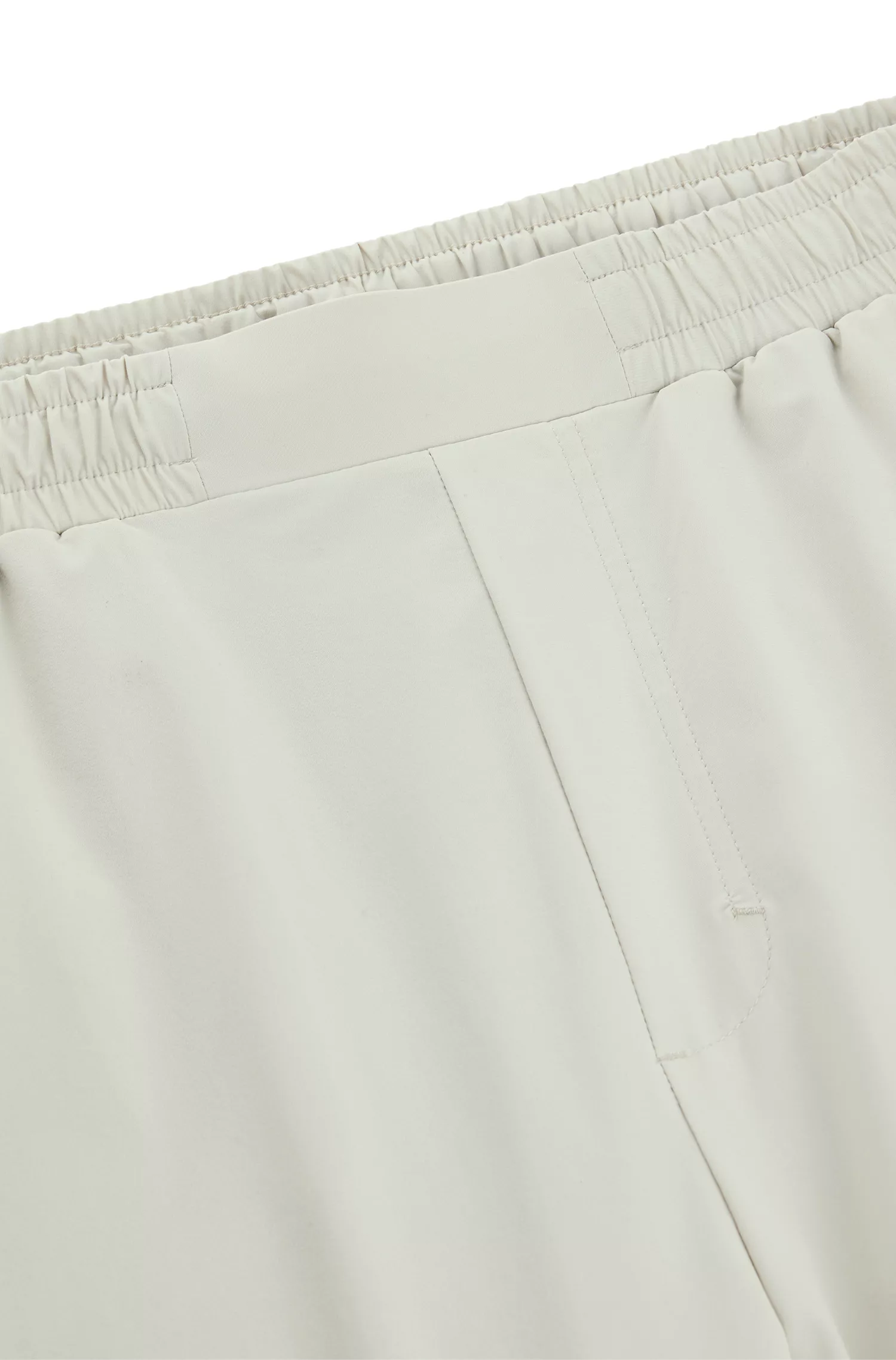 Calça de fato de treino BOSS verde, corte regular, com detalhes refletores decorativos.