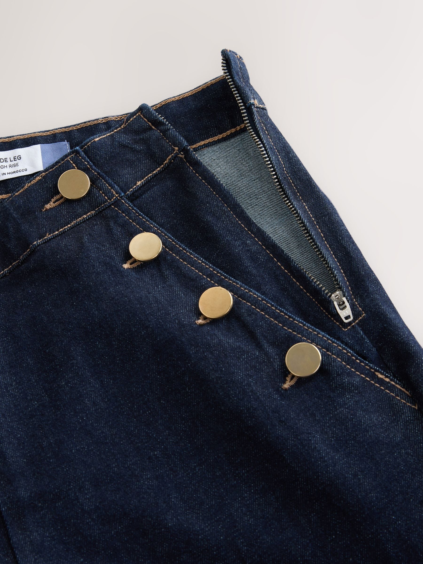 Denim-wassing - Jeans met wijde pijpen en gouden knopen aan de voorkant