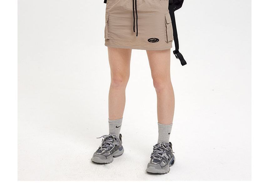 Nariele - Cropped jack met opstaande kraag en ritssluiting / Mini-kokerrok met trekkoordtaille