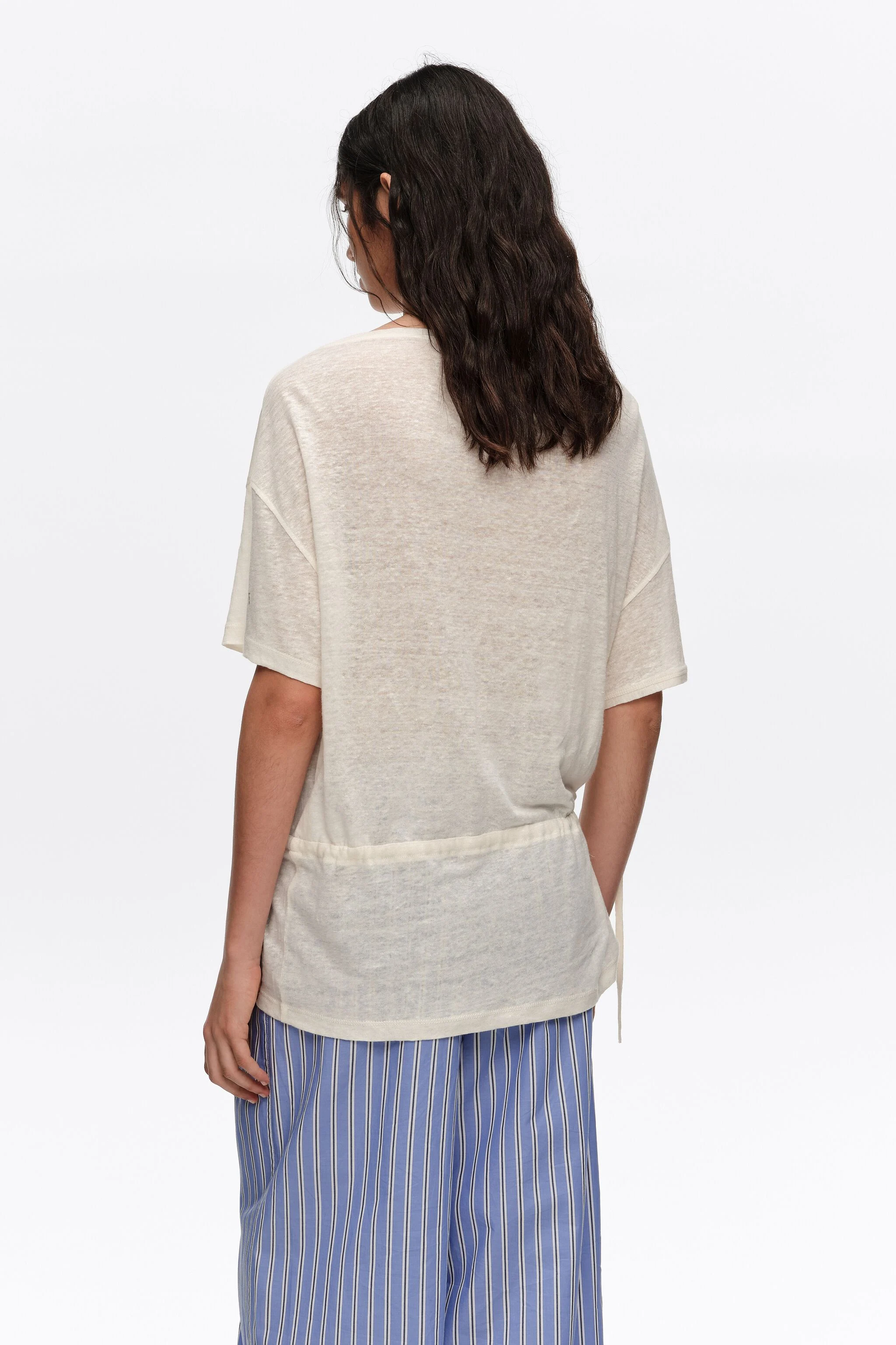 Camiseta de linho cor marfim com cintura ajustável.