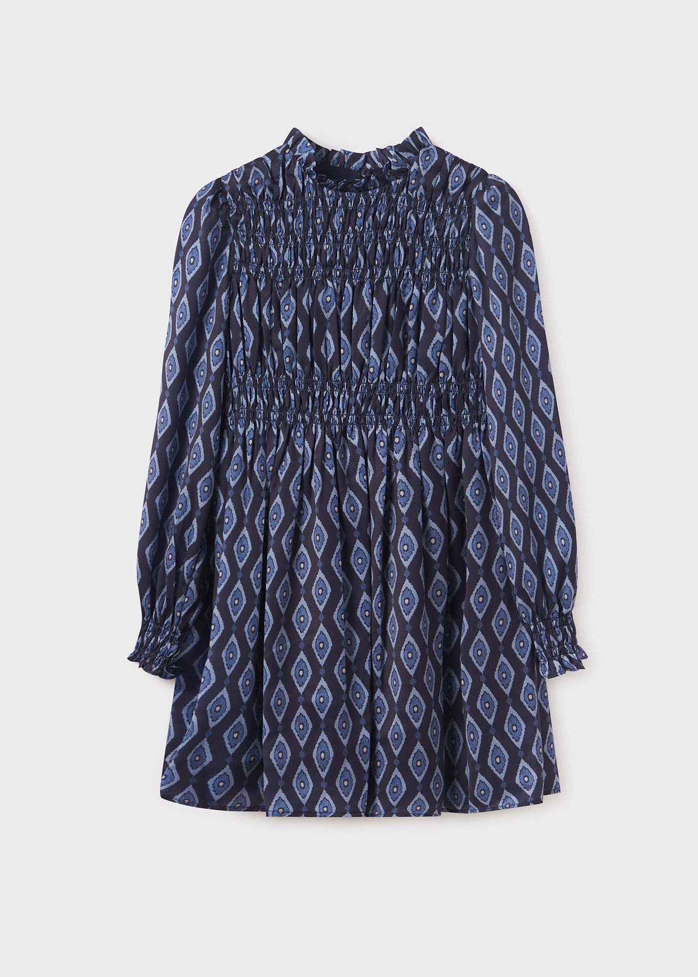 Vestido infantil com estampa de bolinhas e detalhes franzidos.