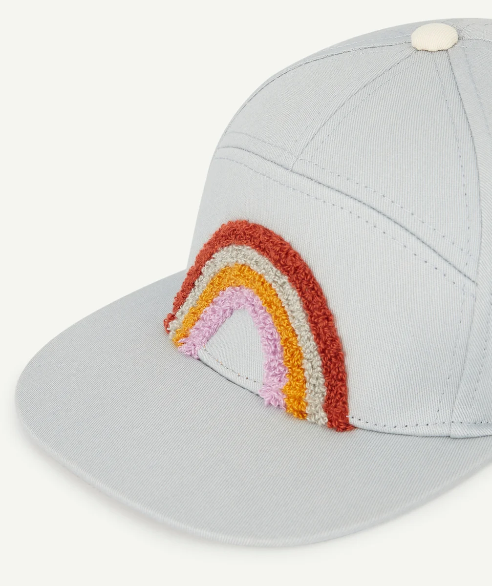 LASSIGCASQUETTE BLEU CIEL AVEC ARC-EN-CIEL EN BOUCLETTE