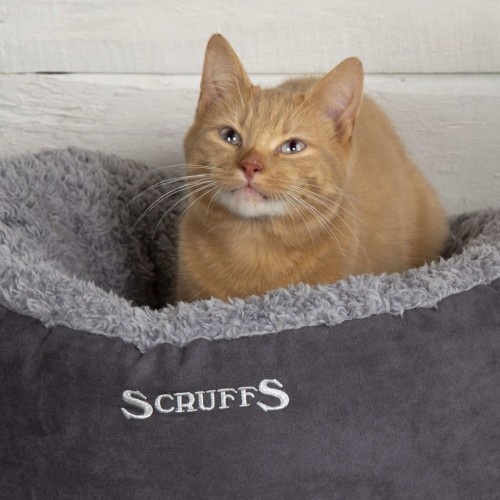 Cama cinza para animais de estimação com forro externo.