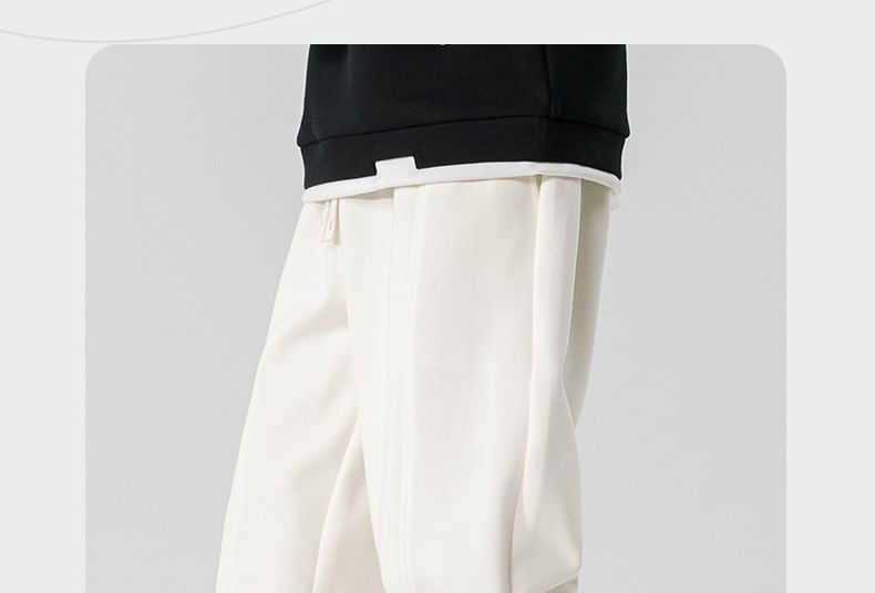 Dandyluxe - Cropped harem-joggingbroek met trekkoord en geborduurde letters